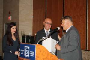 Toronto Councillor Jim Karygiannis presents Mr. Ozsoy with a speacial scroll